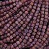 Close-up of purple beads arranged in a pattern