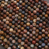 Close-up of multicolored beads with a brown and black color scheme.