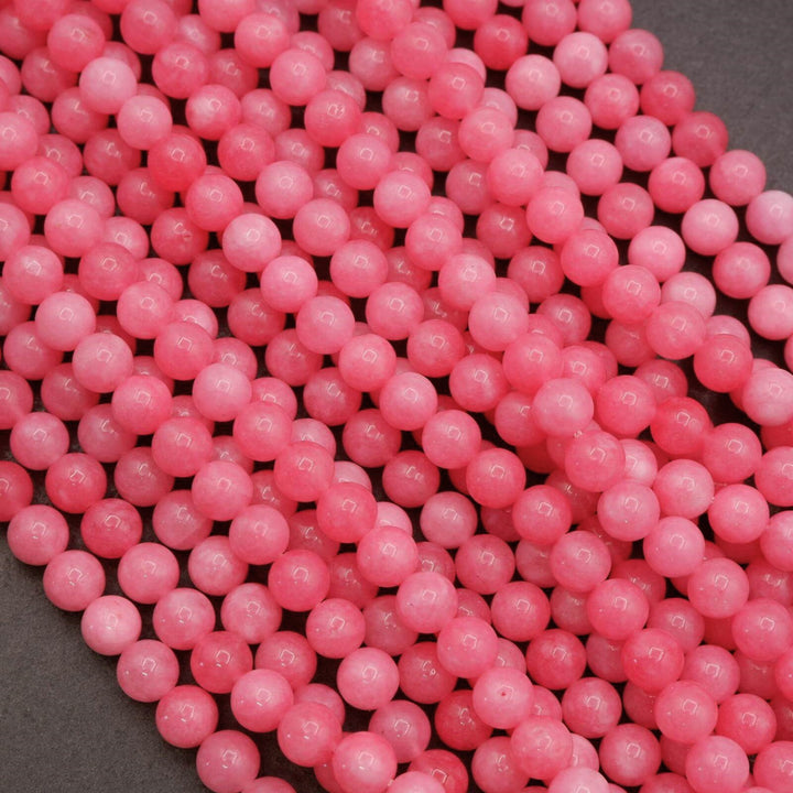 Close-up of pink jade beads showing smooth glossy finish