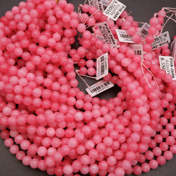 Polished pink jade beads arranged in multiple strands