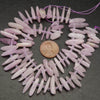 Pink kunzite stick shape beads.