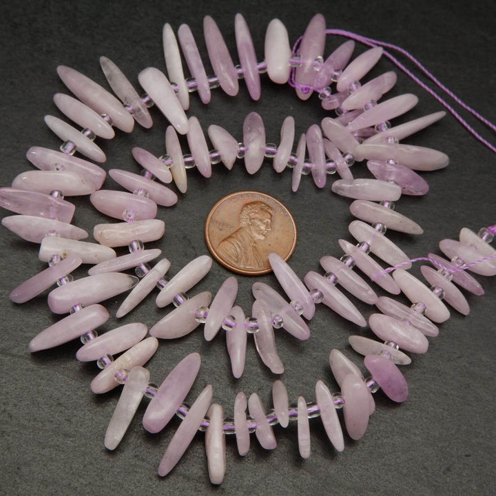 Pink kunzite stick shape beads.