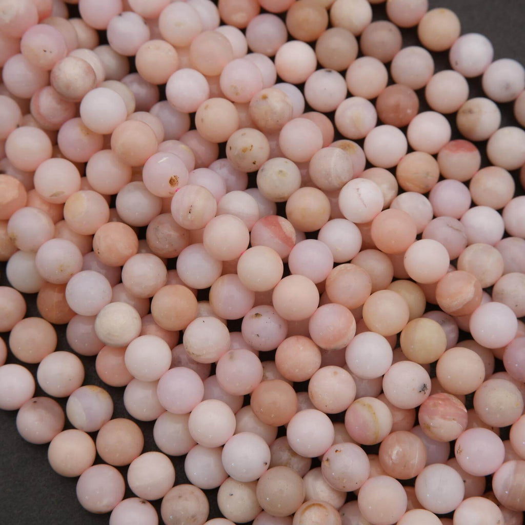 Close-up of pinkish-beige beads on a dark background