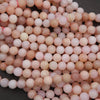 Close-up of pink and beige beads on a dark background