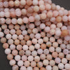 Close-up of pink and white beads on a dark background