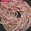 Close-up of pink and beige beads on a dark background
