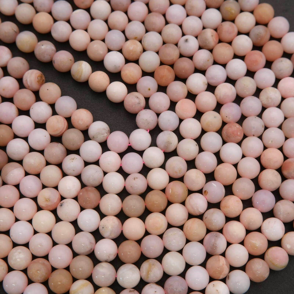 Close-up of pink and white marbled beads on a black background