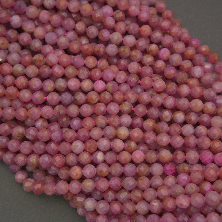 These faceted ruby beads feature muted pink shades with earthy undertones, giving the strand a refined yet natural appearance.