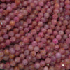 Faceted pink ruby beads displaying soft rose and raspberry tones, natural inclusions, and a gentle sparkle across the strand.