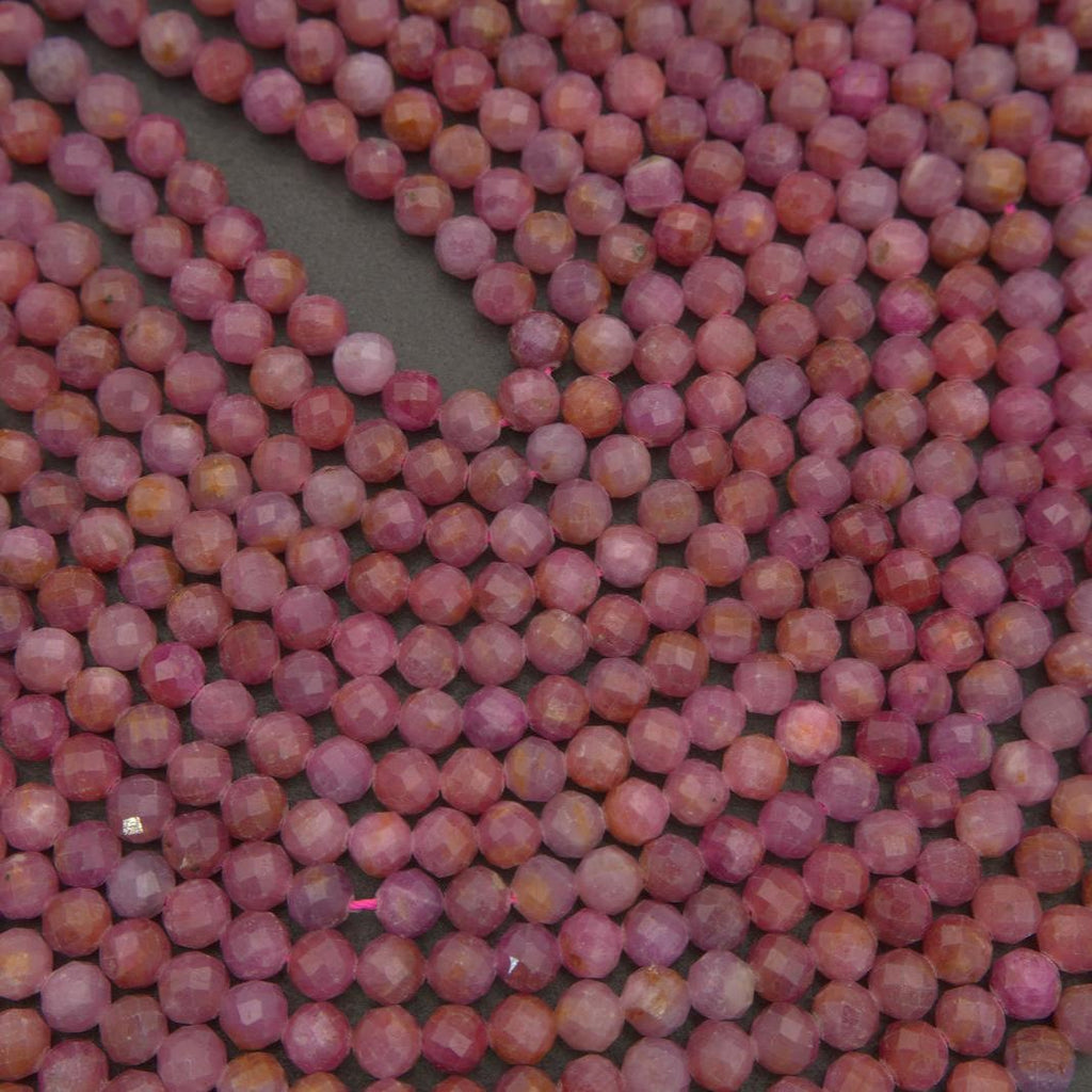 Faceted pink ruby gemstone beads with a calm, organic color palette and gentle luster that highlights their natural formation.