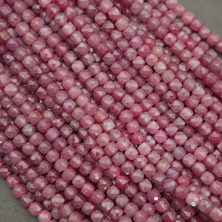 Natural ruby beads in soft to vivid pink tones, faceted finish