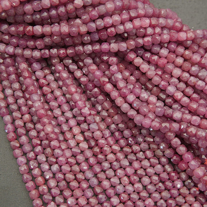 Strands of natural ruby gemstone beads with subtle sparkle