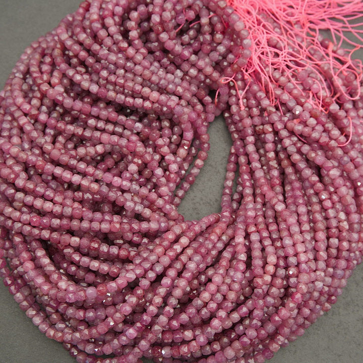 Pink ruby faceted beads with organic inclusions and color variation