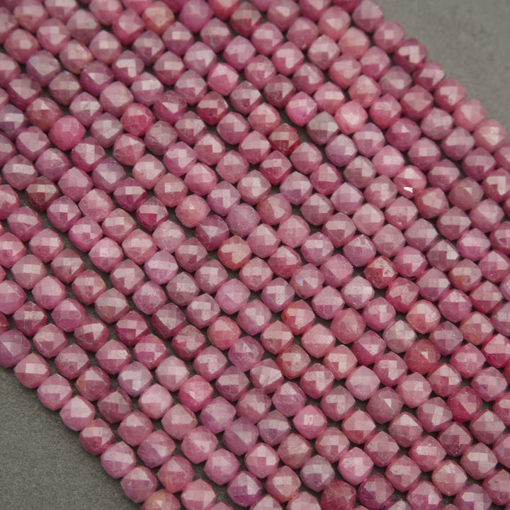 Ruby gemstone beads cut into small faceted rounds