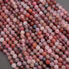 Close-up of pink and red marbled beads on a gray background