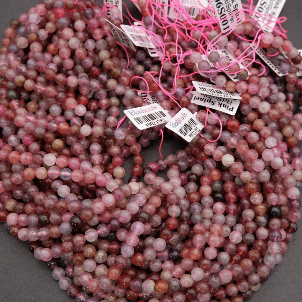 Stack of multicolored beads with price tags on a gray surface