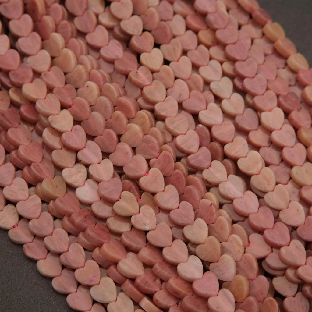 Close-up of pink heart-shaped stones on a dark surface