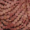 Close-up of pink heart-shaped beads.