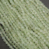 Close-up of light green beads on a dark background