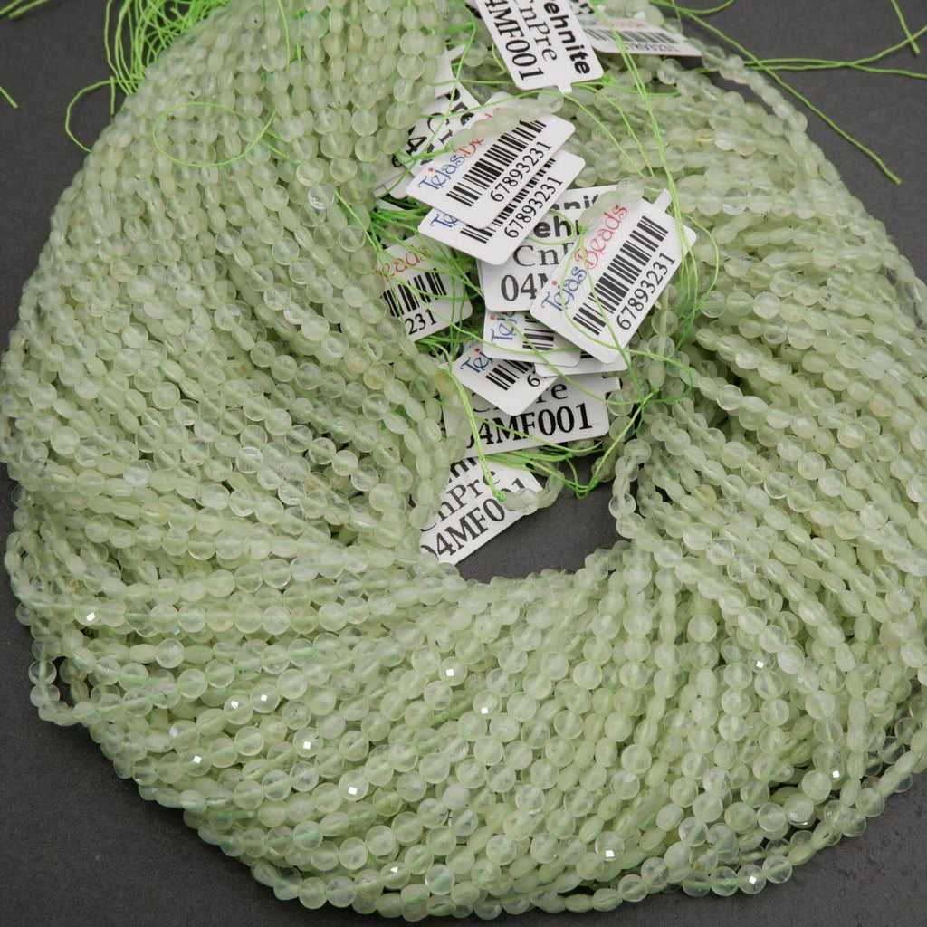 Green beaded string with price tags on a dark surface