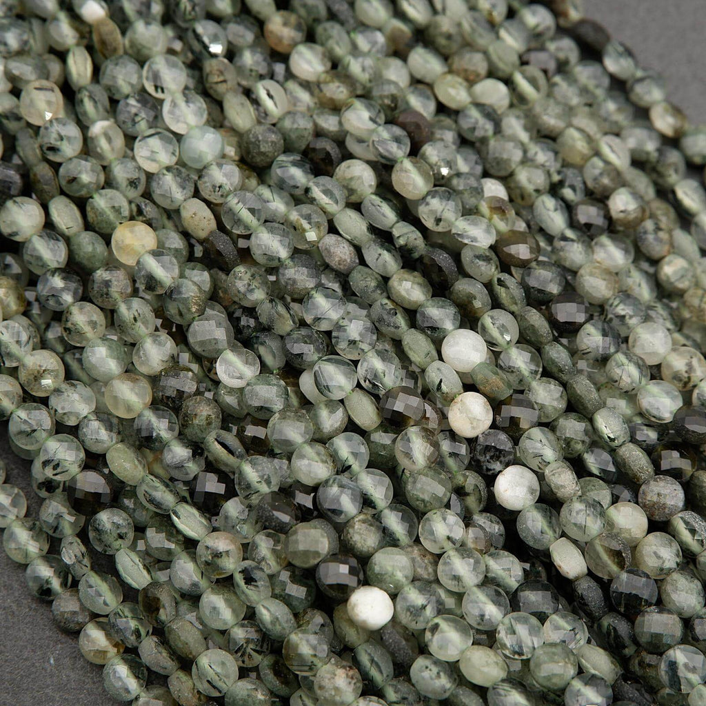 Close-up of green and white beaded necklace on a gray background