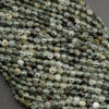Close-up of green faceted beads on a gray background