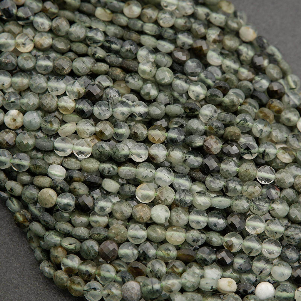 Close-up of green faceted beads on a gray background
