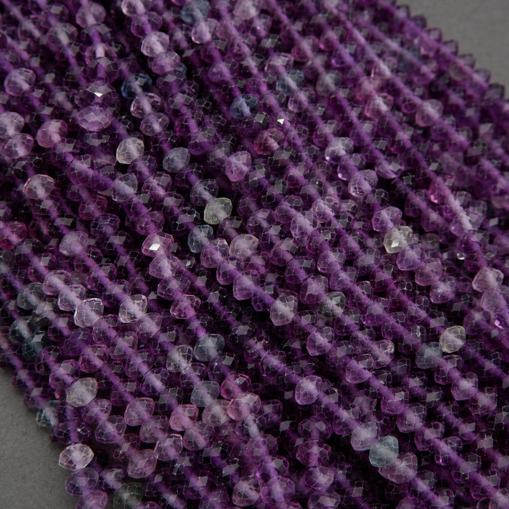 Close-up of a string of purple beads on a gray background