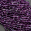 Close-up of purple beads on a gray background