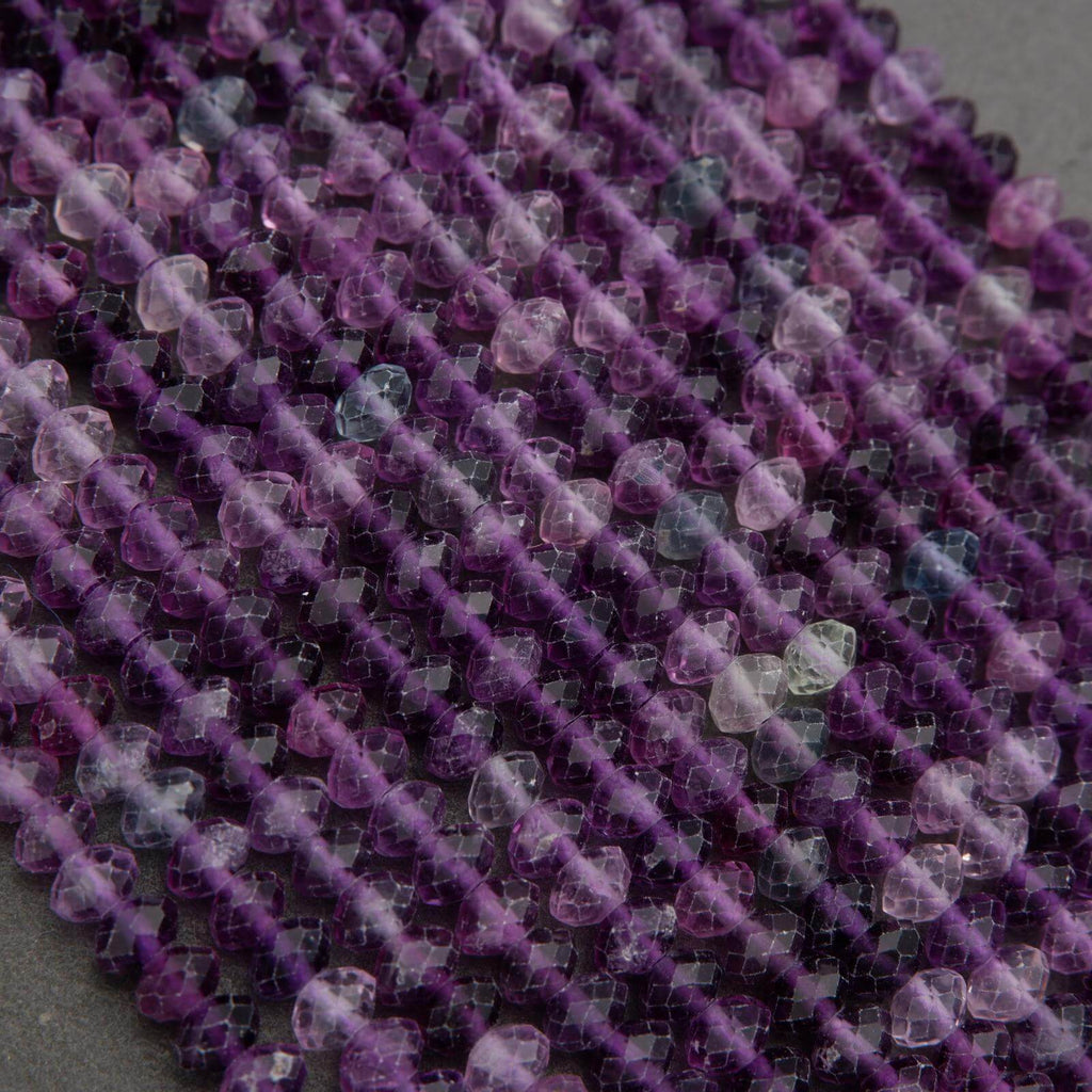 Close-up of purple and pink beads on a string