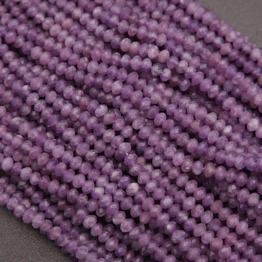 Close-up of a string of purple beads on a gray background