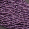Close-up of purple beads on a gray background