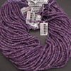 Purple beads with labels on a gray background