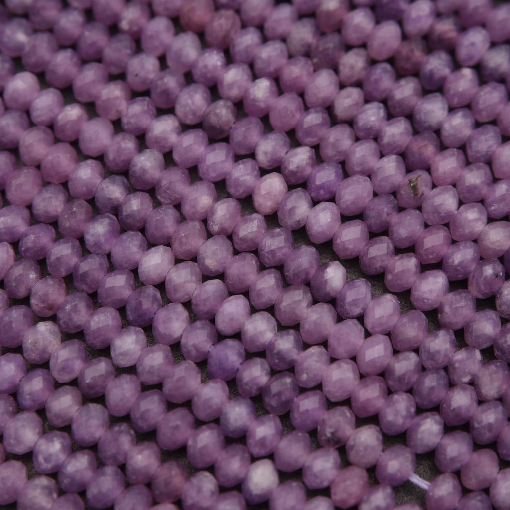 Close-up of purple beads on a string
