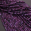 Close-up of purple beads on a dark background