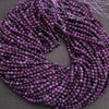 Purple beaded string on a dark background