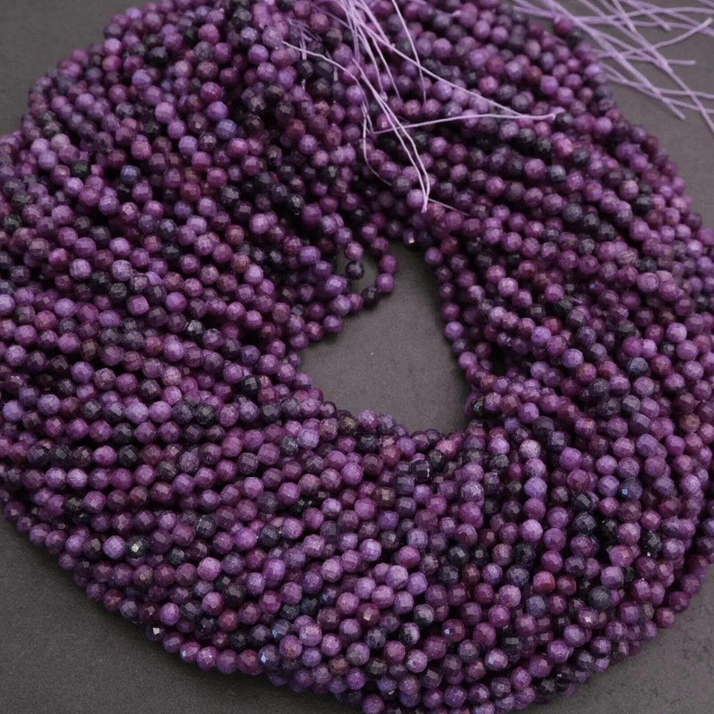 Purple beaded string on a dark background