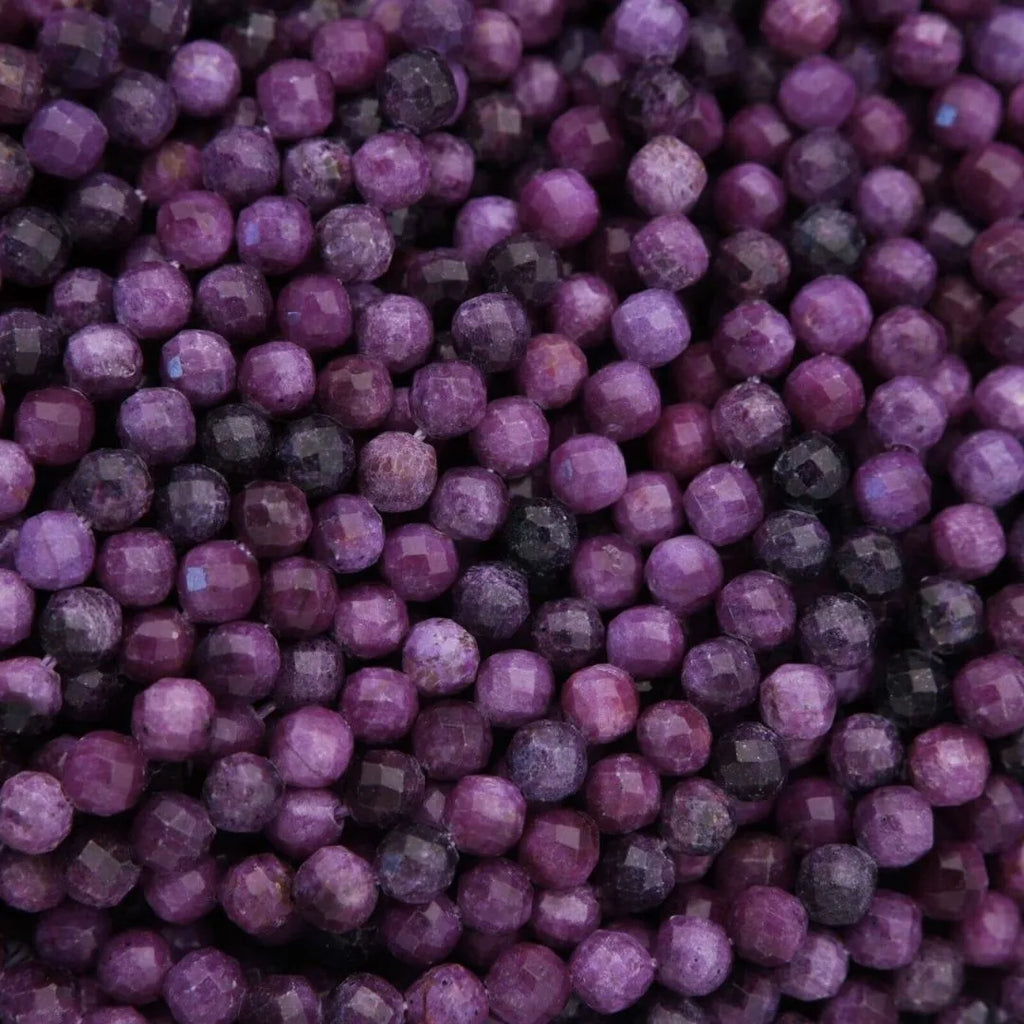 Close-up of purple beads with a dark background