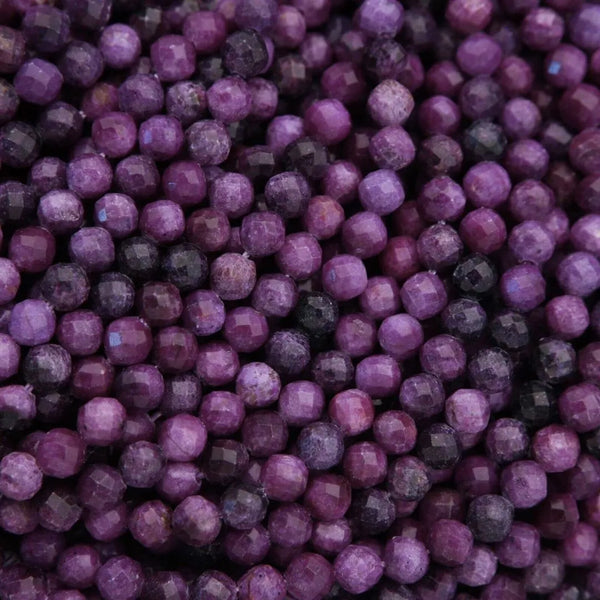 Close-up of purple beads with a dark background