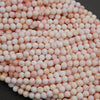 Light pink faceted round beads.