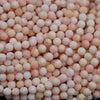 Light pink faceted round beads.