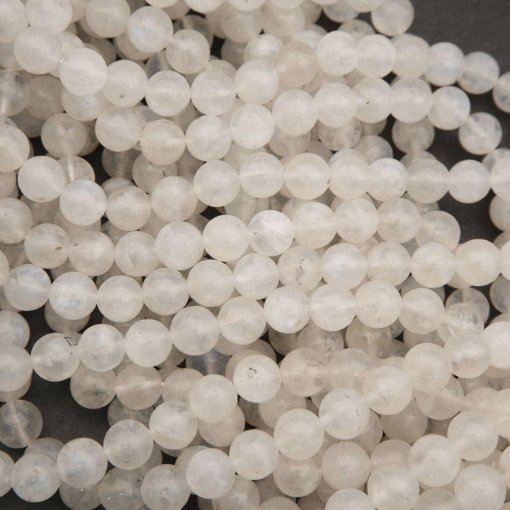 Close-up of white beads on a dark background