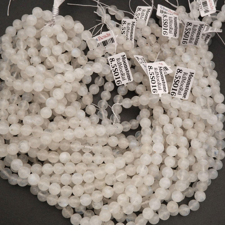 String of white beads with price tags on a dark background