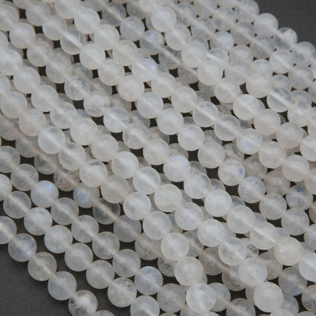 Close-up of white beads on a dark surface