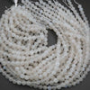 String of white beads on a dark background
