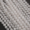 Close-up of white spherical beads on a dark background