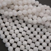Close-up of white spherical beads on a dark background
