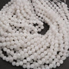 Close-up of a string of white beads on a dark background