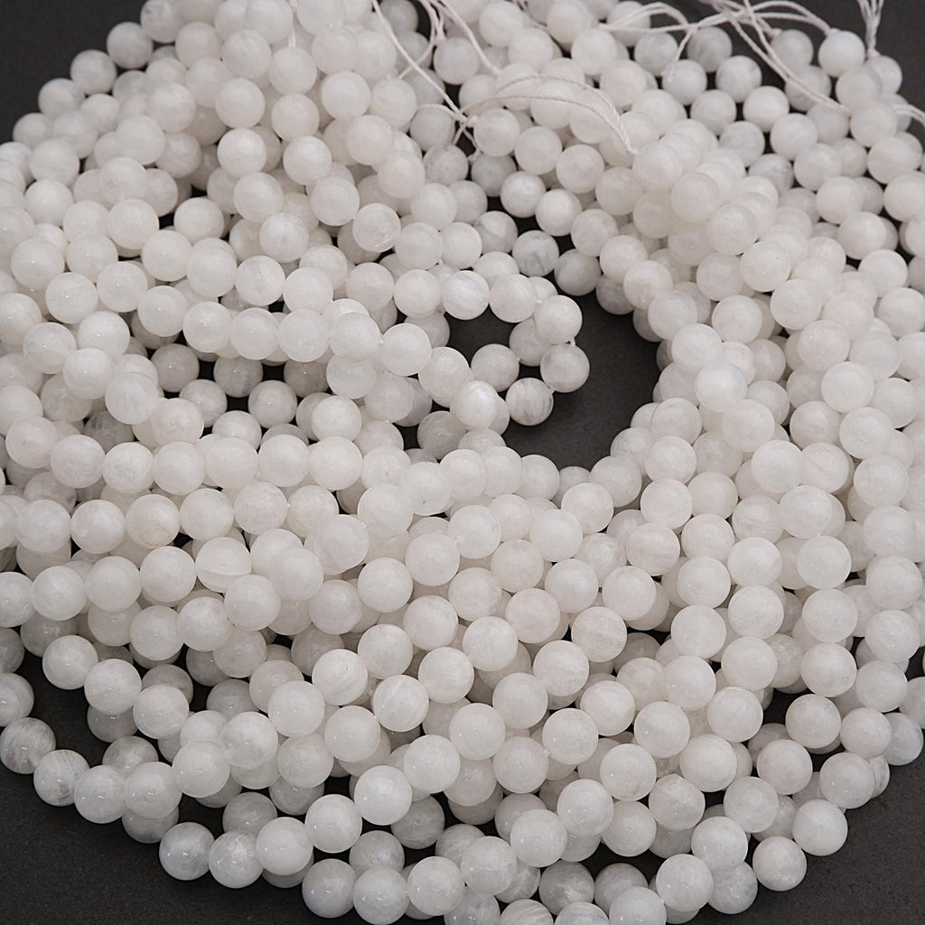Close-up of a string of white beads on a dark background