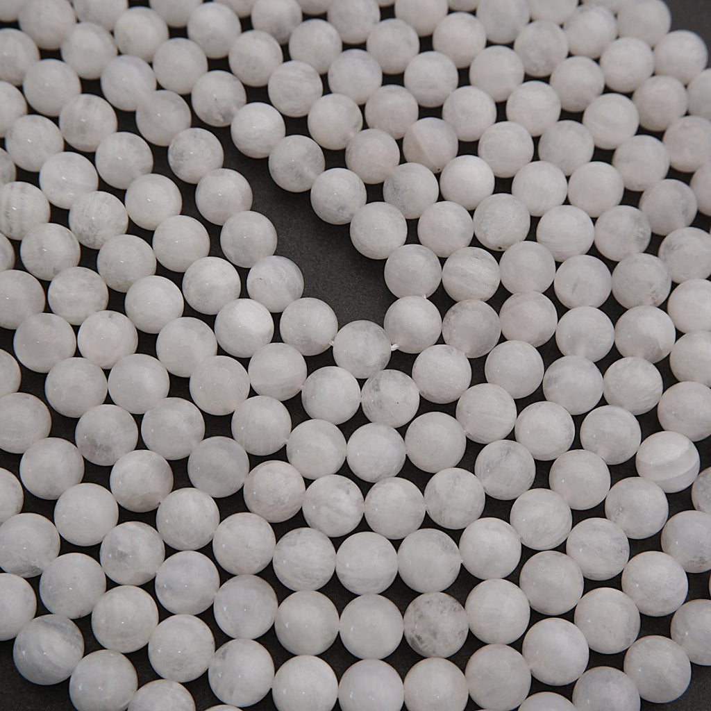 Close-up of white spherical beads on a dark background